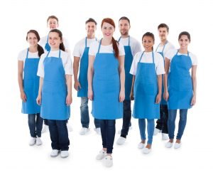 Diverse group of professional cleaners. Isolated on white